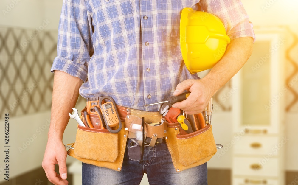 Male worker with tool belt isolated on white  background