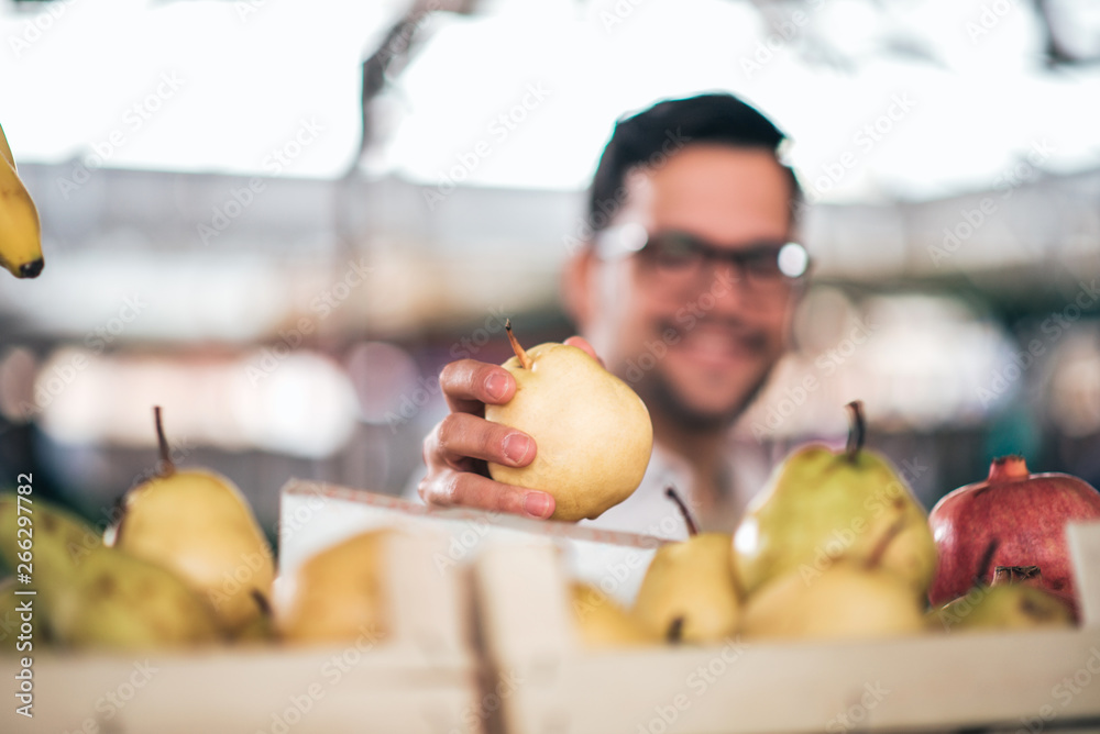 At farmers market, focus on the fruit on the foreground.