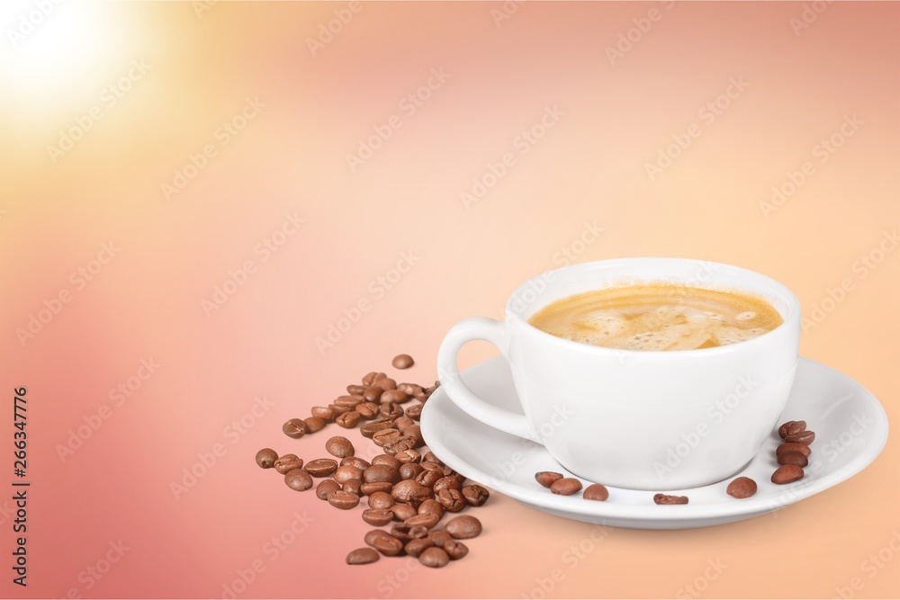 Coffee cup and coffee beans on  background