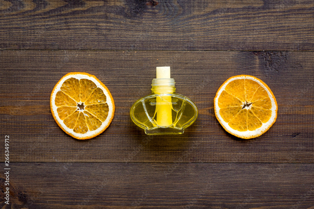 air freshener sticks with orange on wooden background top view