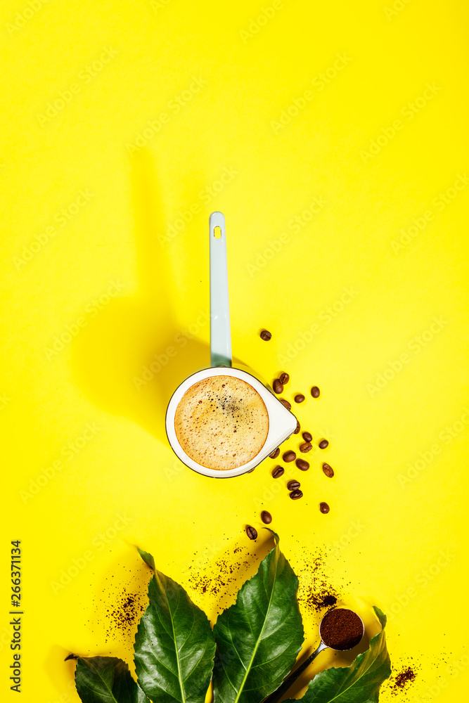 Coffee on yellow background, flat lay, top view