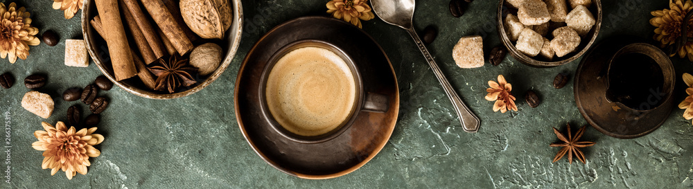 Coffee, flowers and spices on old green background