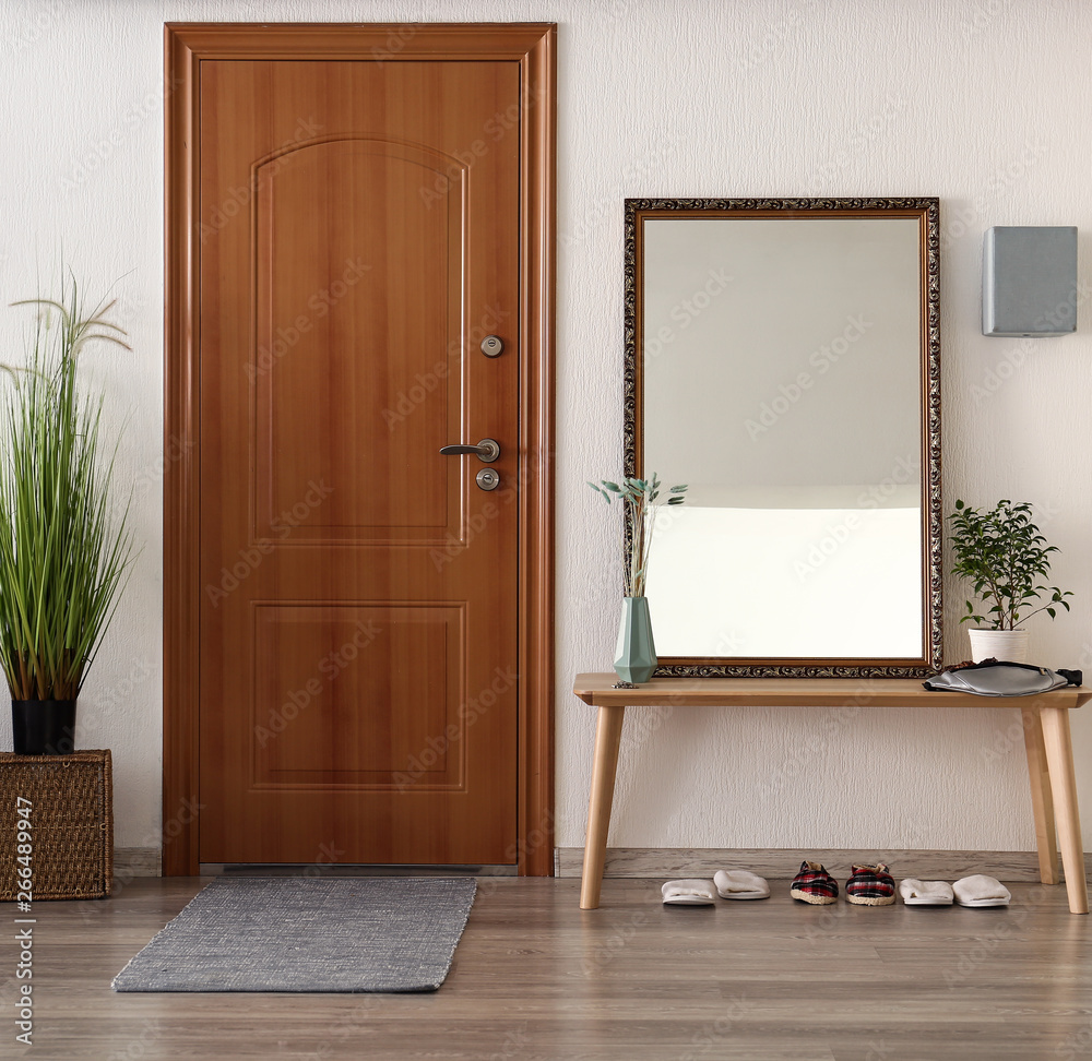 Table with big mirror in interior of hall