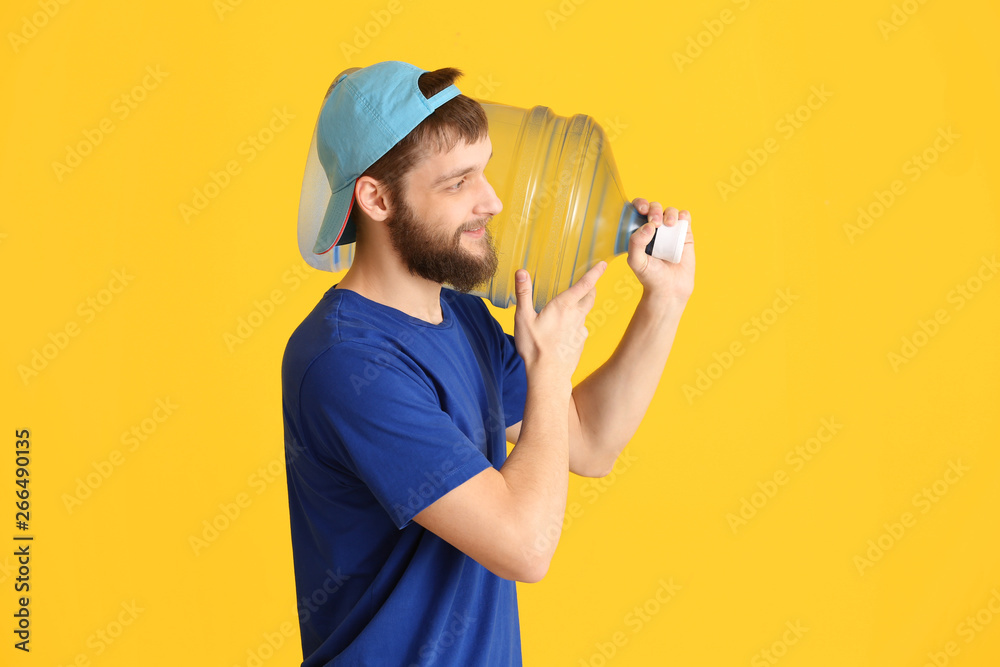 Delivery courier with bottle of water on color background