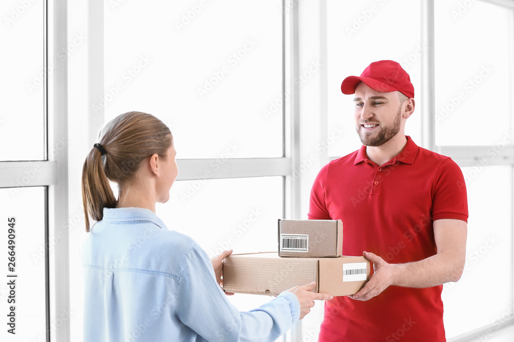 Woman receiving parcels from delivery man