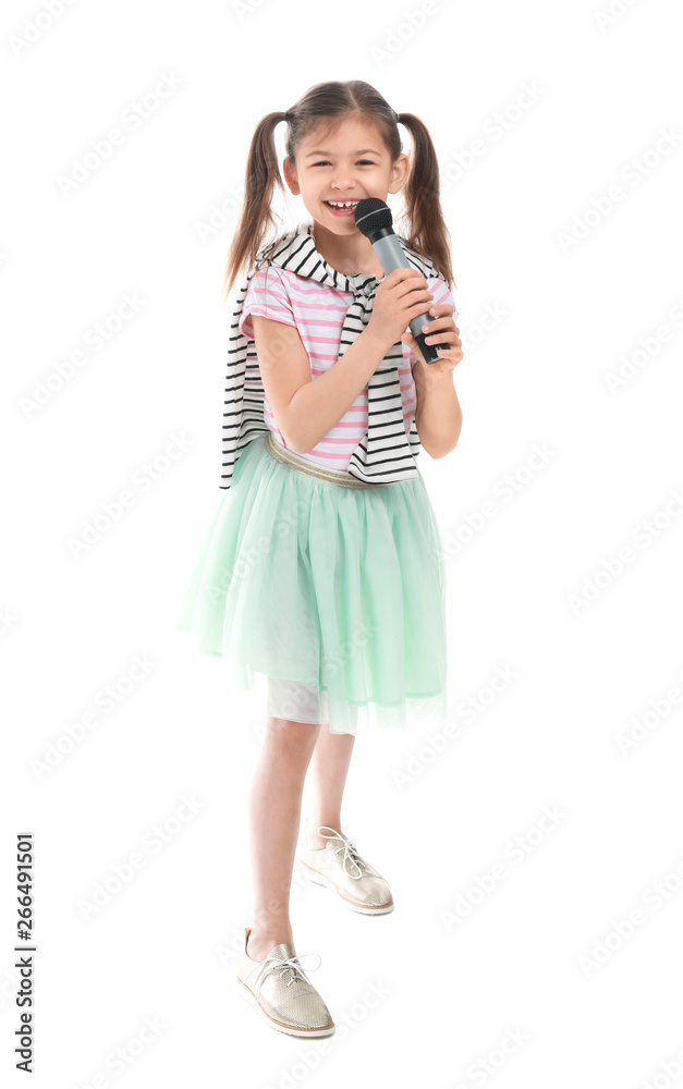 Little girl with microphone singing against white background