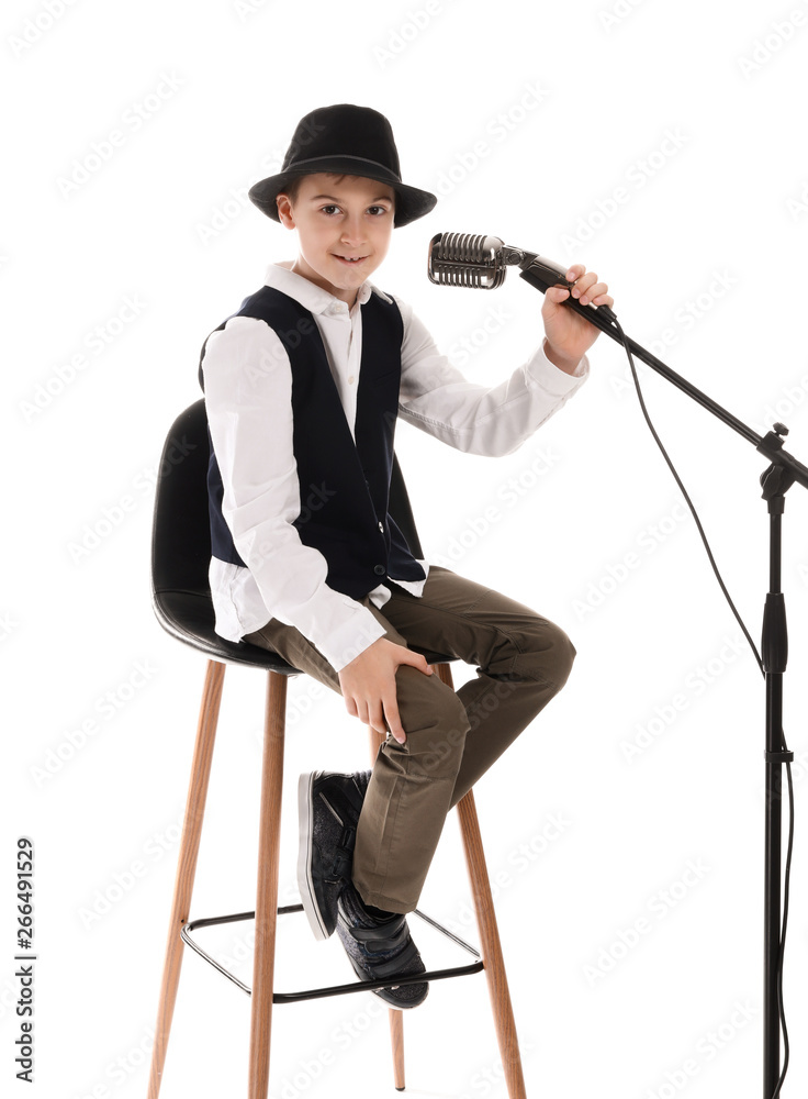 Little boy singing in microphone against white background