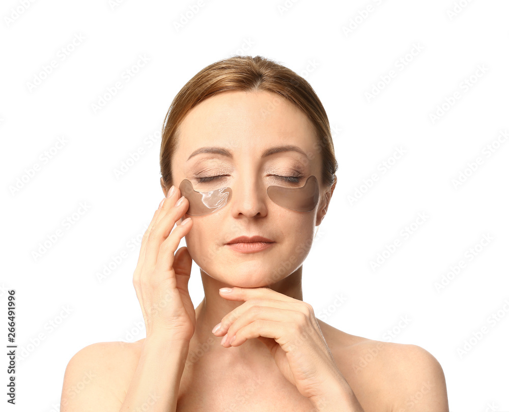 Mature woman with under-eye patches on white background