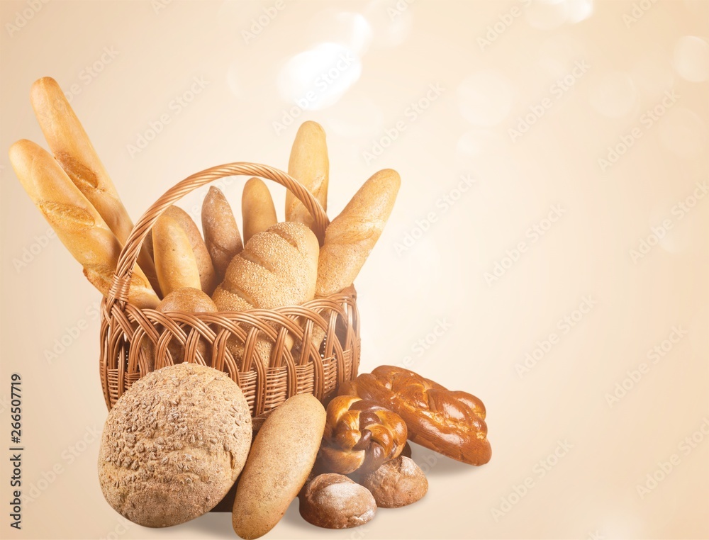 Composition with bread  in wicker basket isolated on white