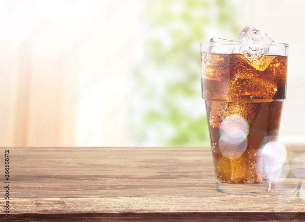 Glass of cola with ice cubes isolated on white background