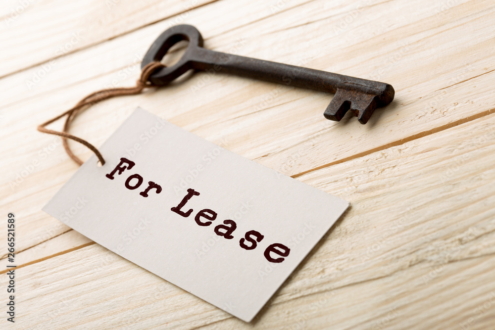 real estate lease concept - old key with tag