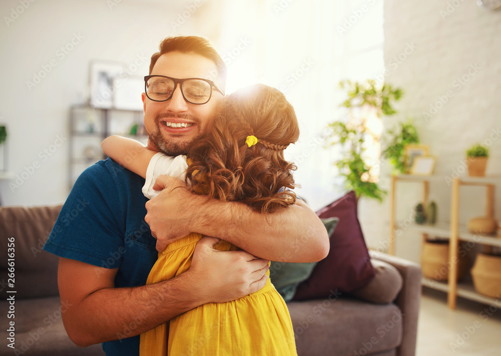 Fathers day. Happy family daughter hugs his dad  .