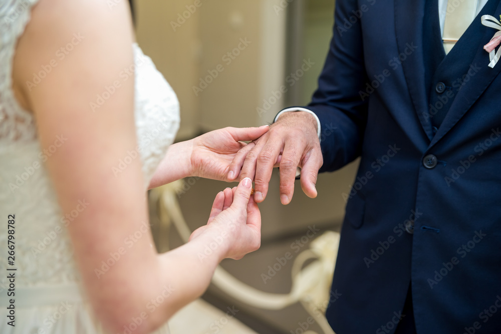 Wedding rings. The bride wears a wedding ring on the groom.