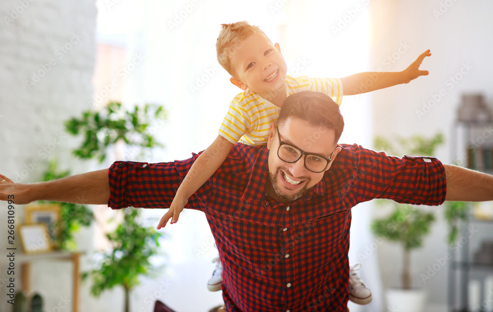 Fathers day. Happy family son hugs his dad  .