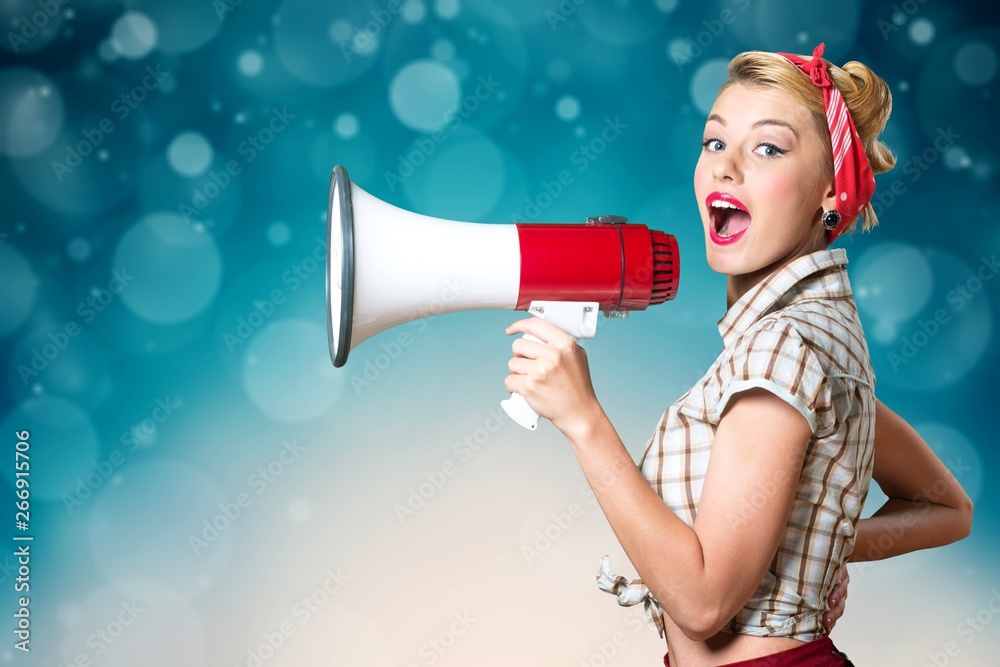 Portrait of woman holding megaphone, dressed in