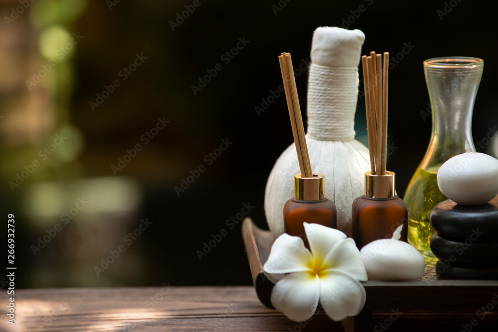 Spa massage therapy setting, nature product,Towel salt with candles and black hot stone on wooden ba