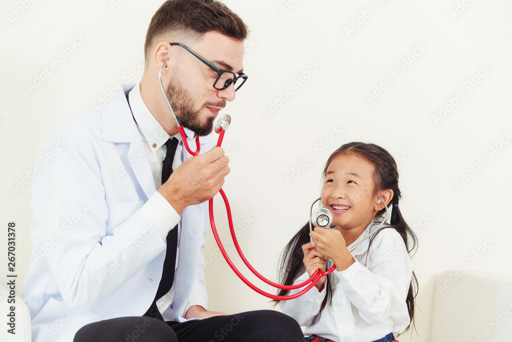 Little kid visit doctor in hospital office. The kid is happy and not afraid of the doctor. Medical a