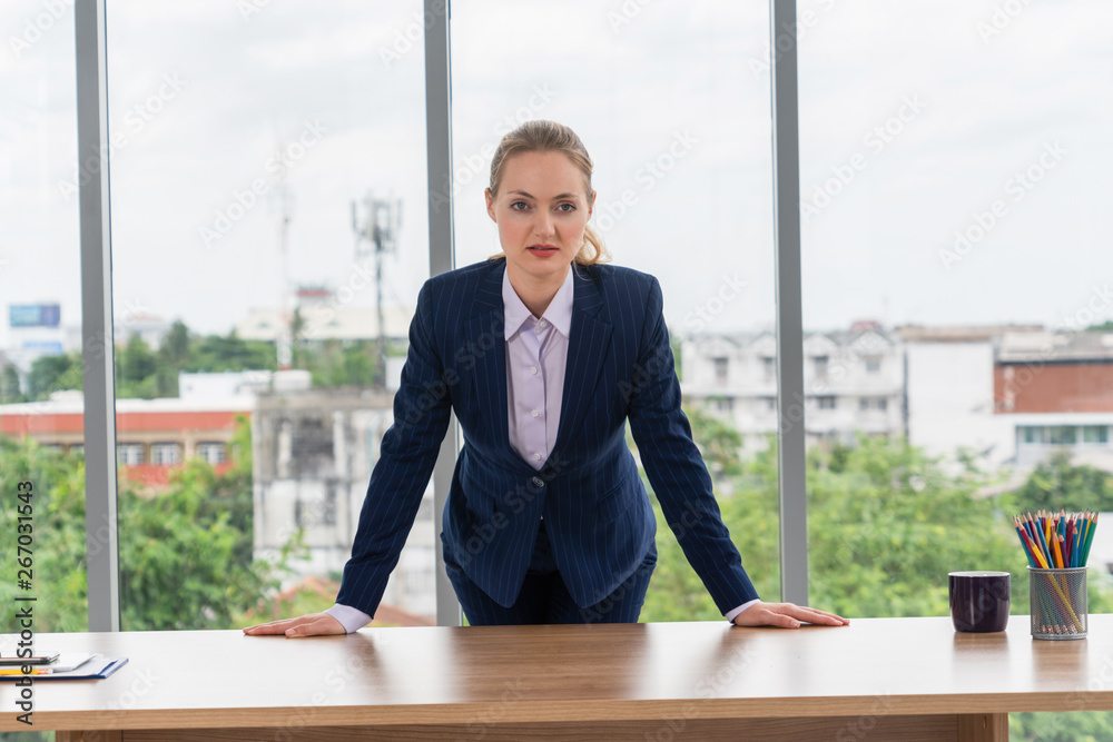 Portrait of businesswoman executive leader at office looking at camera.