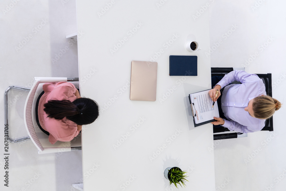 Two young business women in meeting at office table for job application and business agreement. Recr