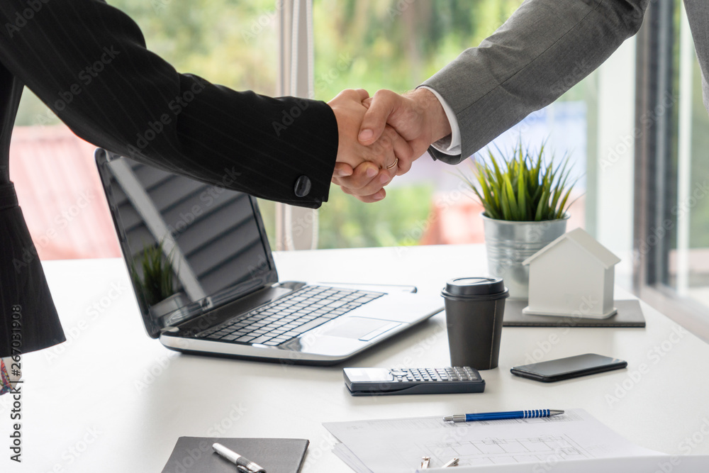 Businessman executive handshake with businesswoman worker in modern workplace office. People corpora