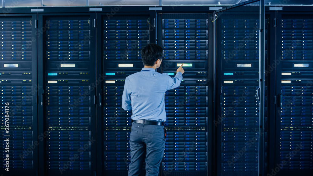 In the Modern Data Center: IT Engineer Standing Beside Open Server Rack Cabinets, Does Wireless Main