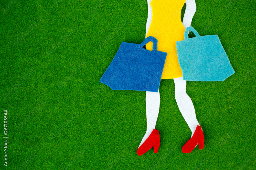 Female legs with shopping bags over bright background