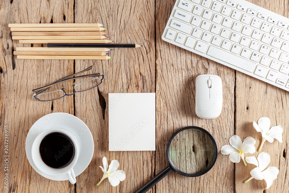 business objects of keyboard,mouse,white coffee cup,white paper,pencils,glasses,magnifying glass and