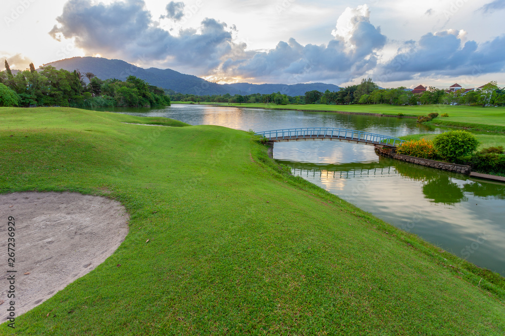 Golf course green grass field and lagoon