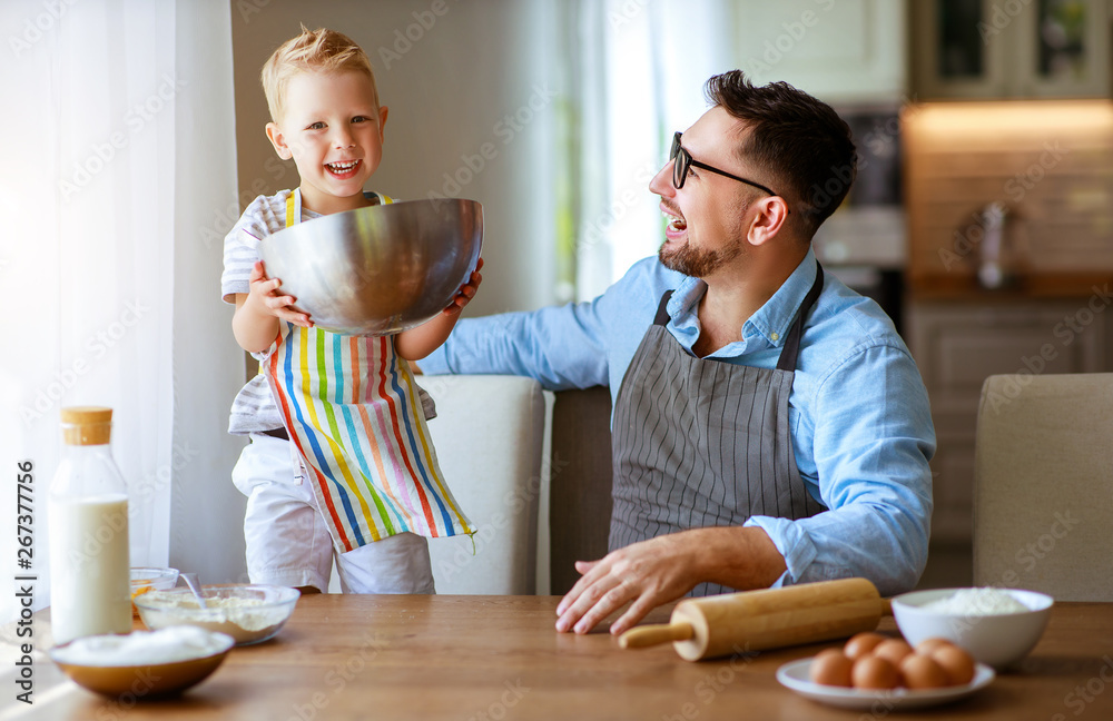 happy family in kitchen. father and child baking cookies  .