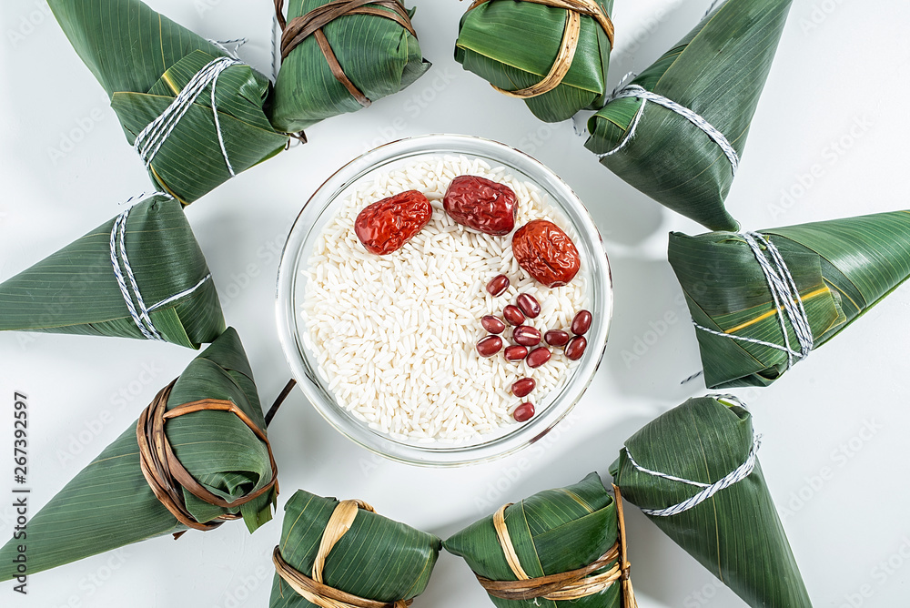 Freshly wrapped hazelnuts and white glutinous rice with red dates on a white background