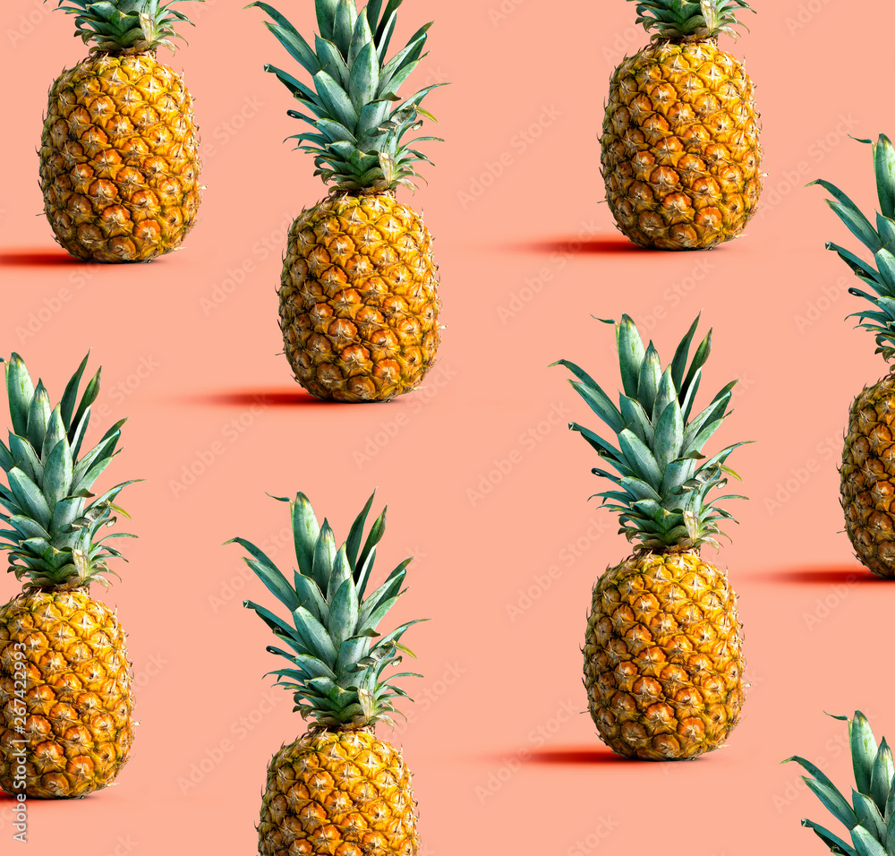 Many pineapples on a solid color background