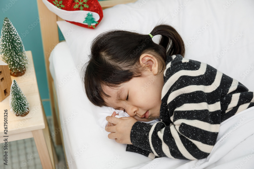 Child girl sleeping on the wooden bed in her bedroom, Happy asian child little girl sleep with blank