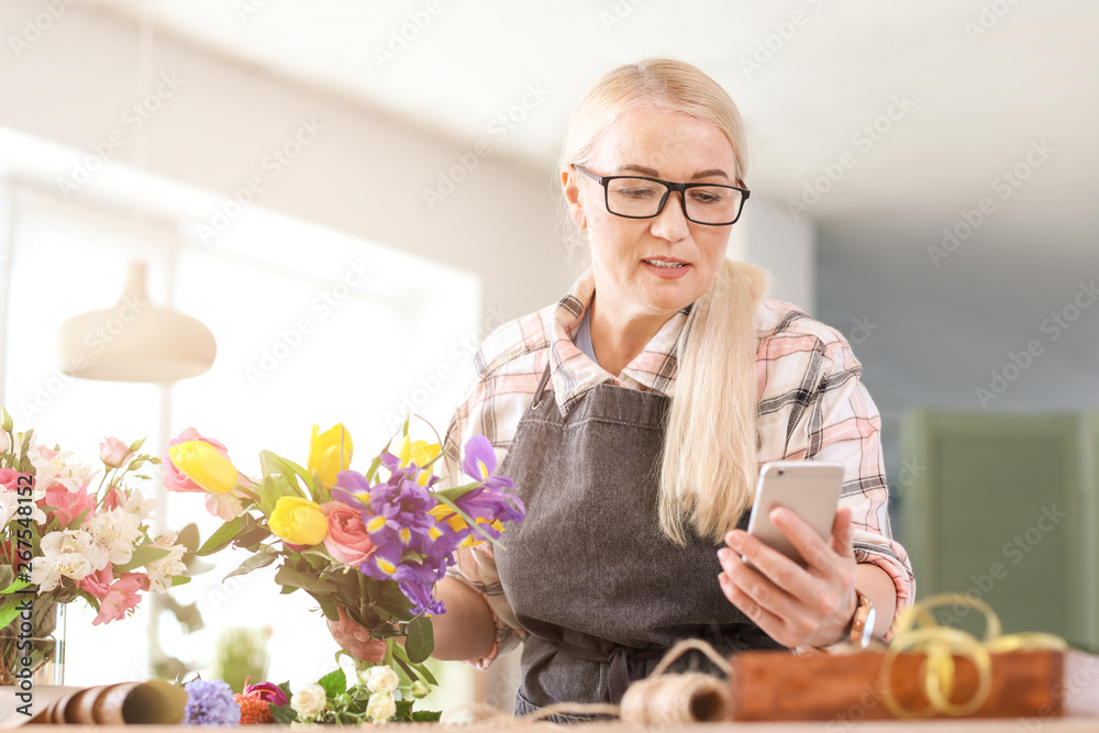 Florist taking order by phone in shop