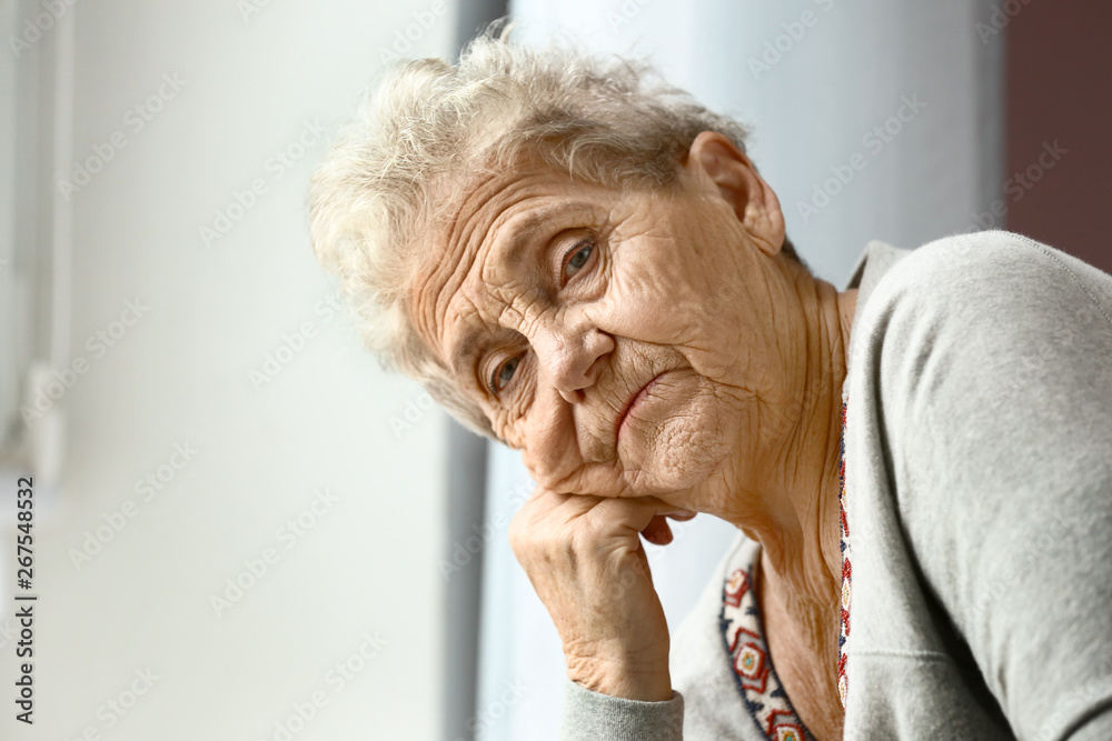 Portrait of depressed senior woman at home