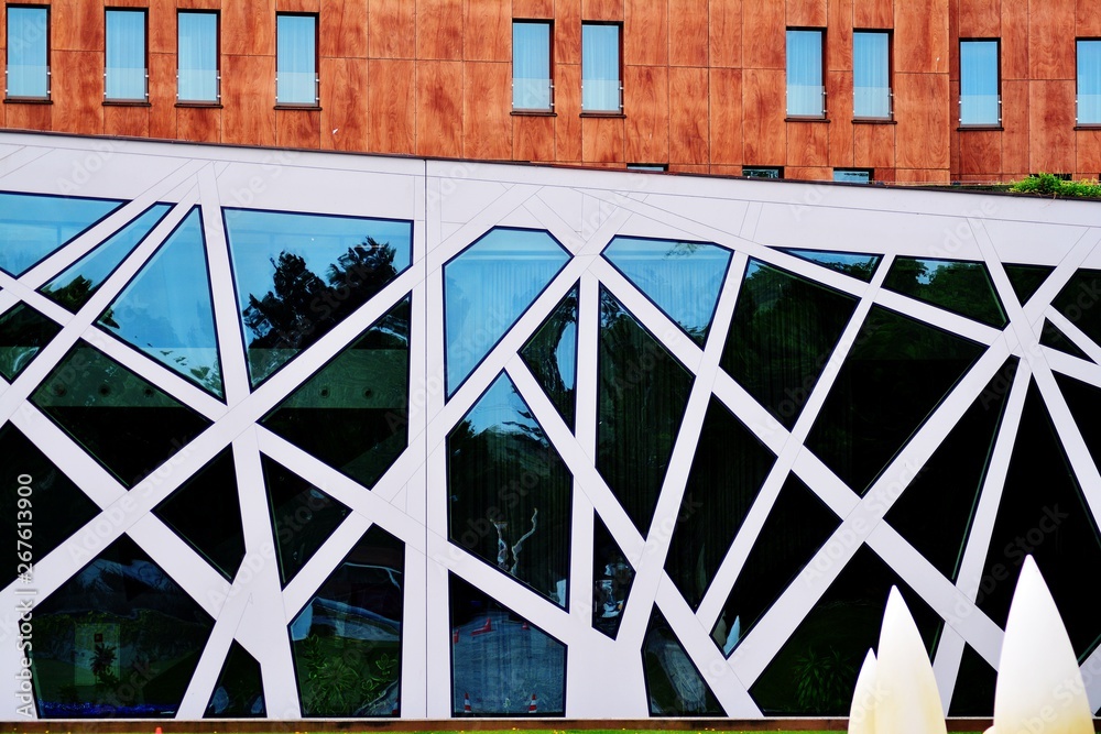 Abstract image of looking up at modern glass and concrete building. Architectural exterior detail of