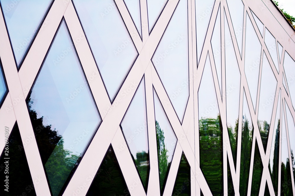 Abstract image of looking up at modern glass and concrete building. Architectural exterior detail of