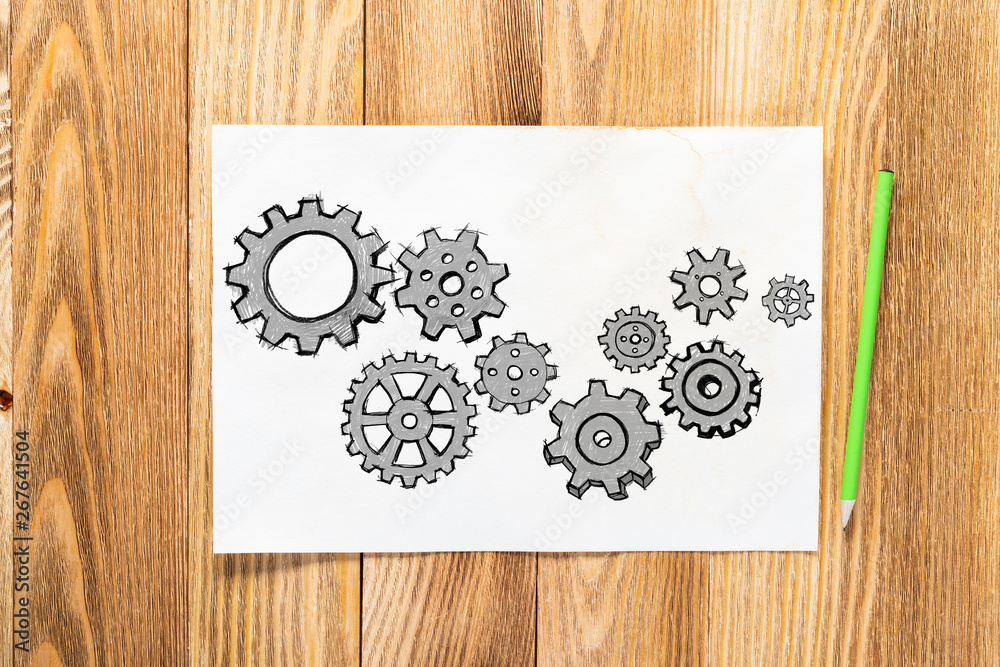 Cogwheels hand drawn illustration on paper sheet