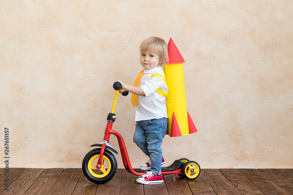 Happy child playing with toy rocket at home