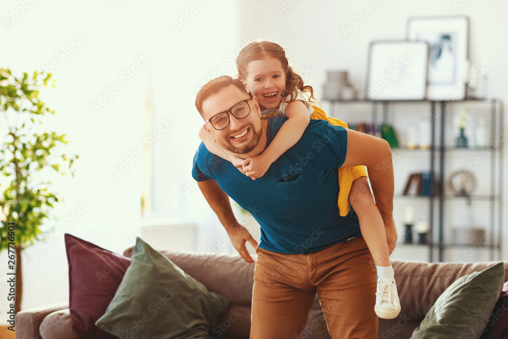 Fathers day. Happy family daughter hugs his dad  .