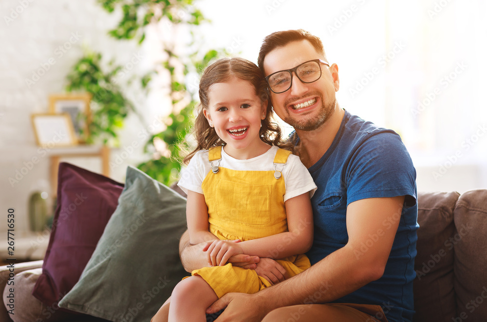 Fathers day. Happy family daughter hugs his dad  .