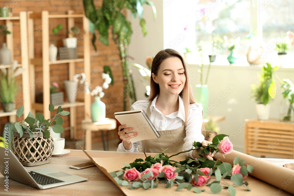 Young florist working in shop