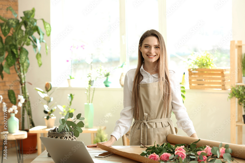 Young florist at workplace in shop