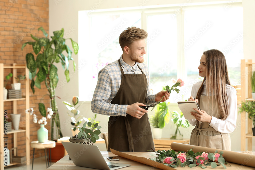 Young florists working in shop