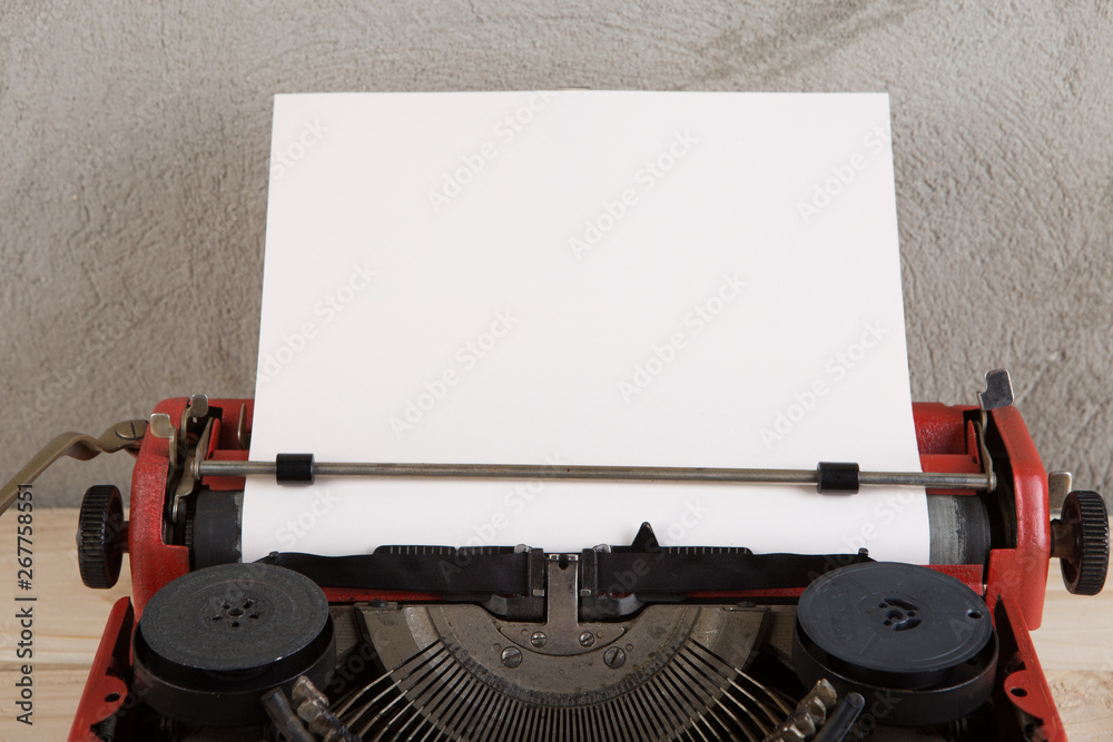 vintage typewriter on the table with blank paper - concept for writing, journalism, blogging