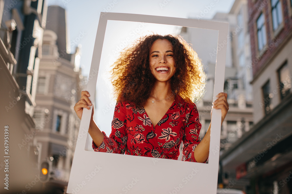 Excited girl with empty photo frame