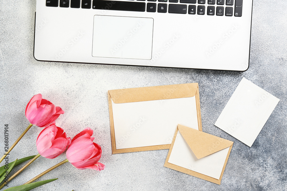 Fresh flower composition, bouquet of bi color pink tulips with black and white laptop computer, conc