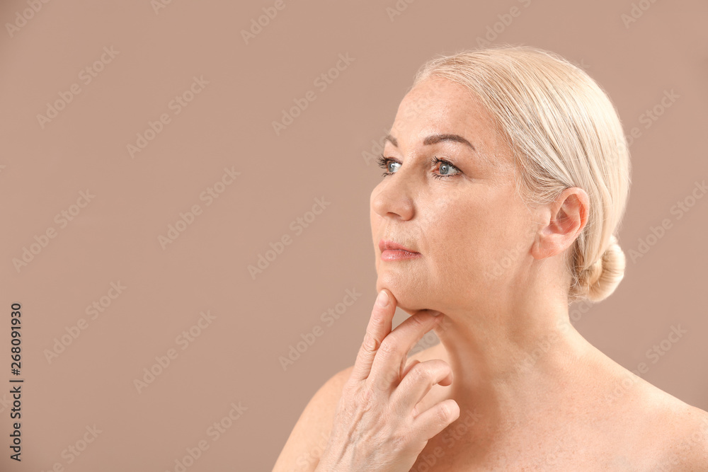 Mature woman on color background