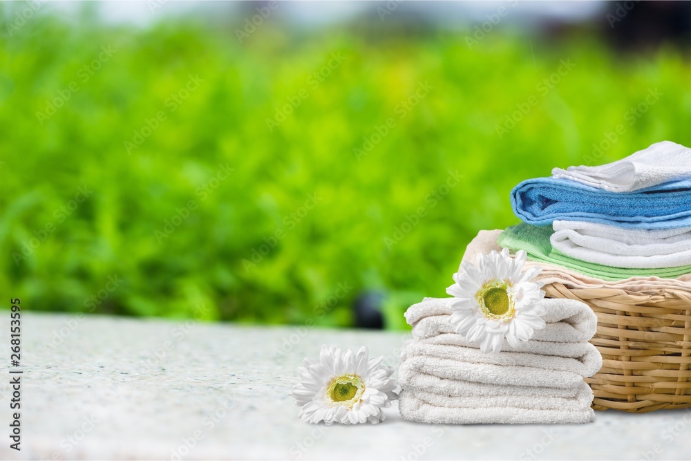 Laundry Basket with colorful towels on background