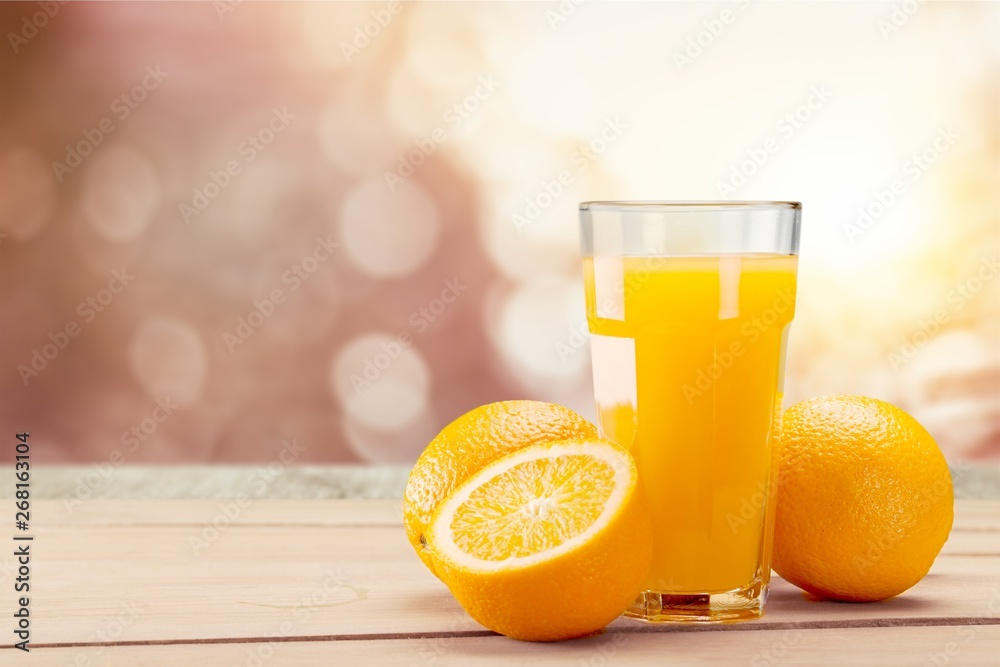 Orange juice and slices of orange on background