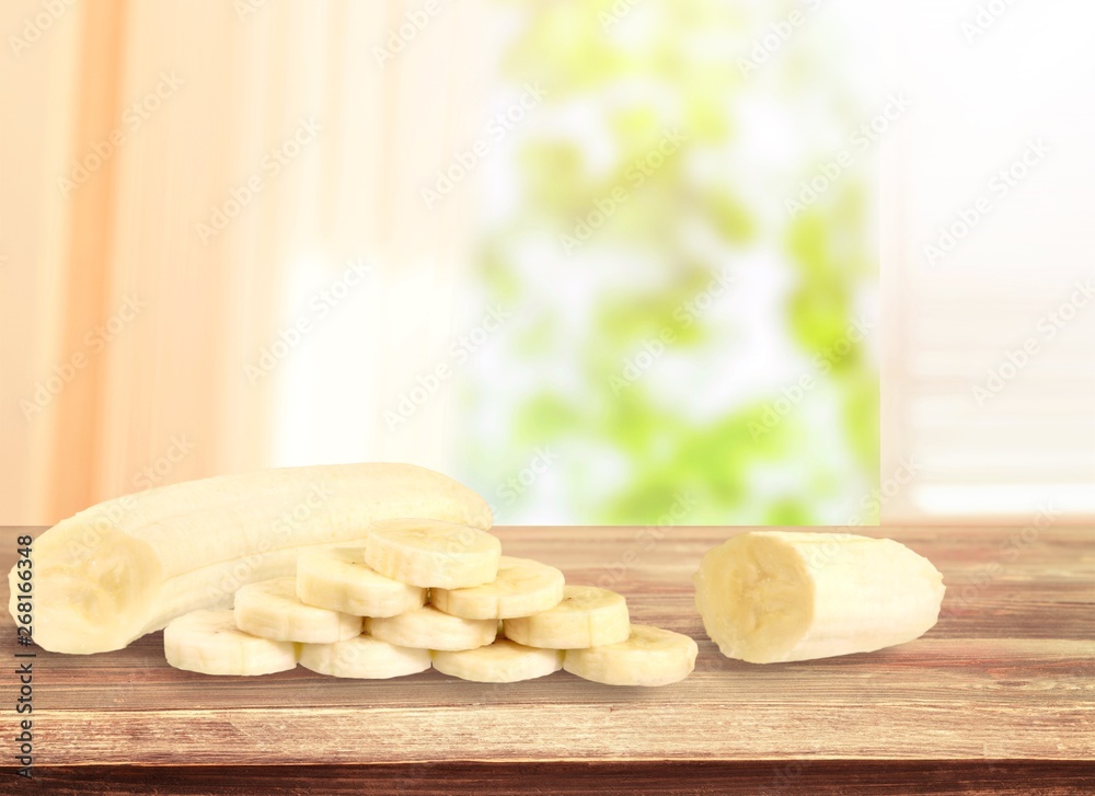 Tasty banana milkshake on wooden table